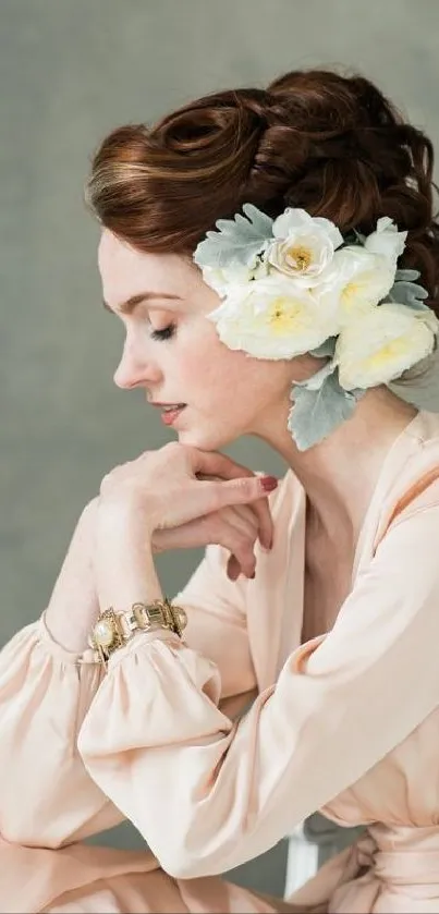 Elegant portrait of a woman with floral headpiece in soft peach tones.