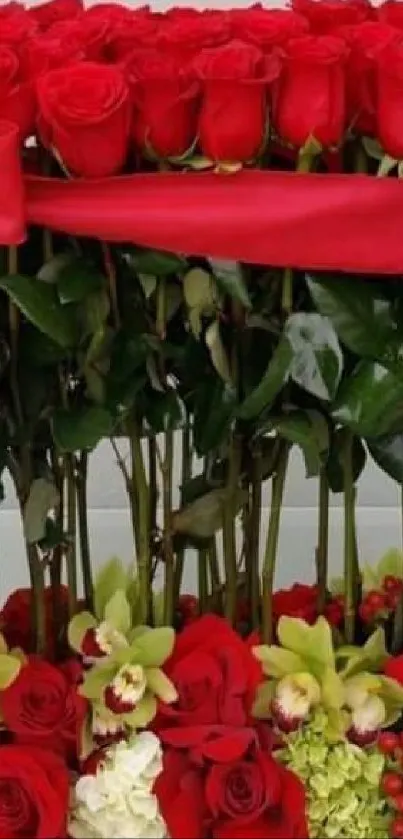 Vibrant red roses with green leaves in a decorative flower arrangement.