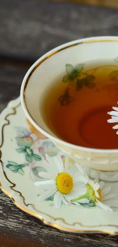 Vintage tea cup with floral design and daisies on a wooden table.