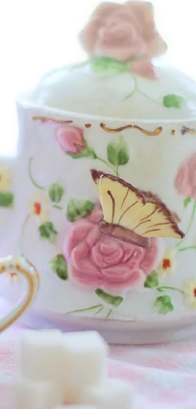 Elegant teapot wallpaper with roses and butterfly design in pastel colors.