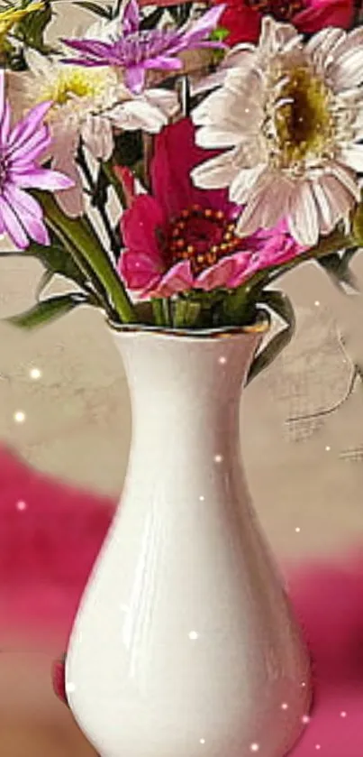 White vase with colorful flowers in a soft pink setting.