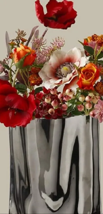 Elegant metallic vase with vibrant flowers.