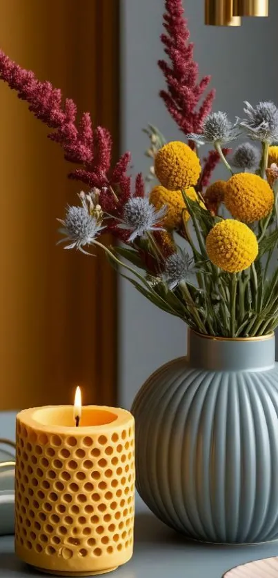 Elegant vase with flowers and candle on table.
