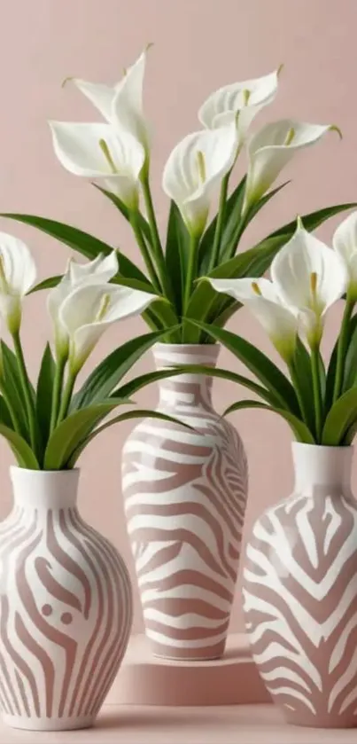 Elegant floral vases with calla lilies on a soft pink background.
