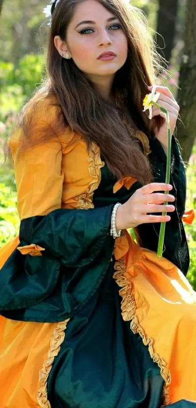 Elegant woman in orange dress with flower in forest setting.