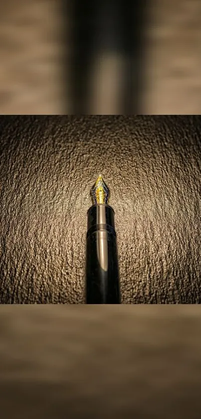 Elegant fountain pen on brown textured background wallpaper.