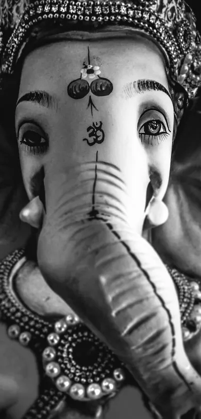 Black and white Ganesha statue with ornate decorations.
