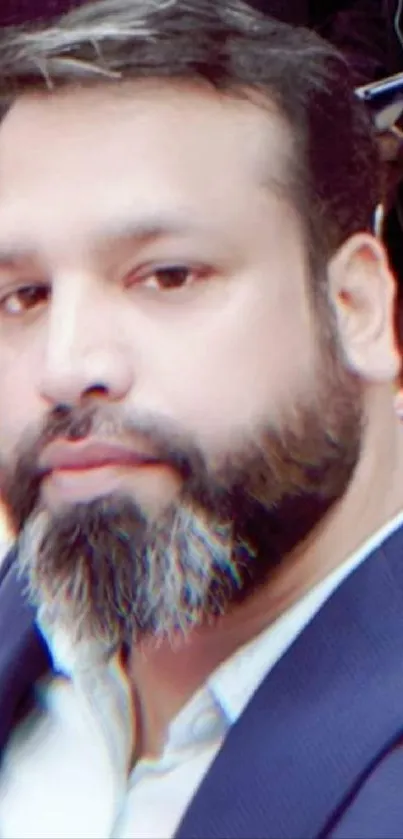 Elegant portrait of a bearded gentleman in a suit.