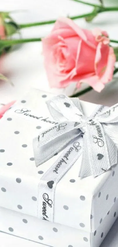 Polka dot gift box with pink roses and silver ribbon.