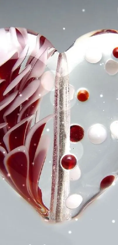 Elegant glass heart with red and white design on a mobile wallpaper.