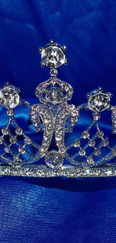 Glittering silver tiara on blue satin background.