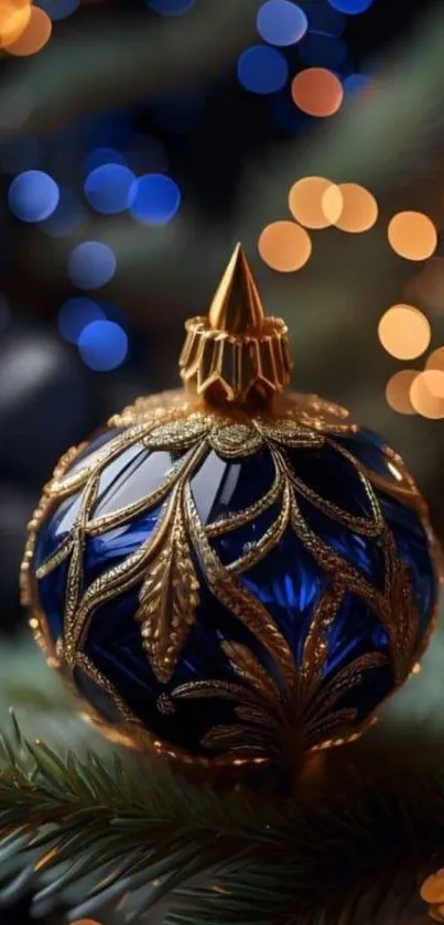 Luxurious blue and gold ornament on a festive Christmas tree with bokeh lights.