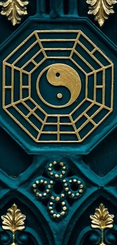 Gold yin yang design on teal wallpaper with intricate details.