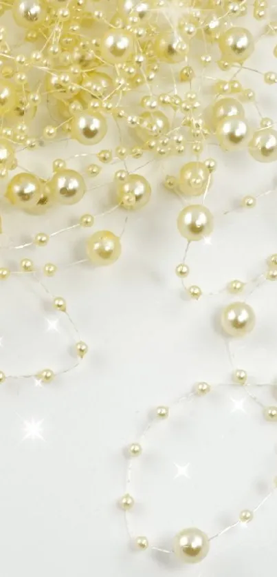 Elegant mobile wallpaper with delicate gold beads on white.