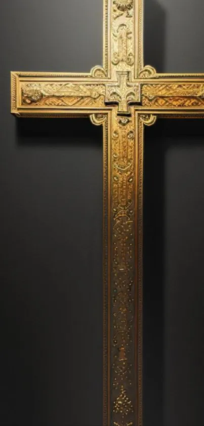 Ornate gold cross with dark backdrop.