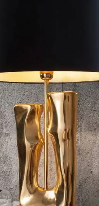 Luxurious gold lamp with black shade against textured wall.