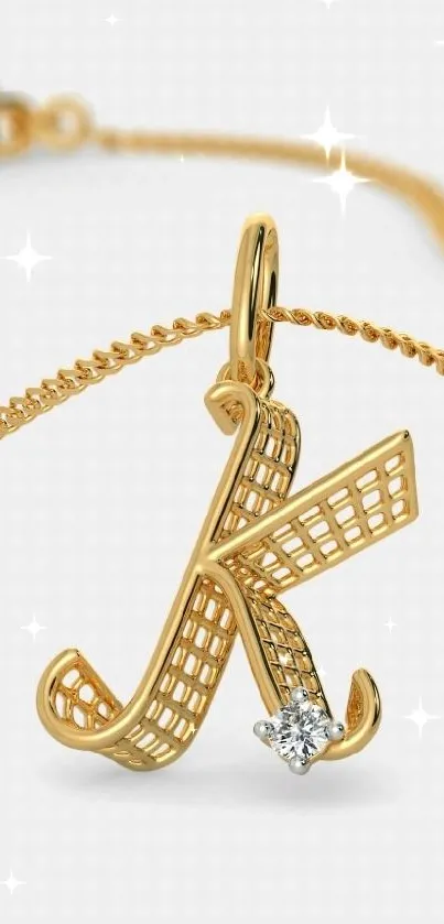 Gold letter necklace charm with diamond detail.