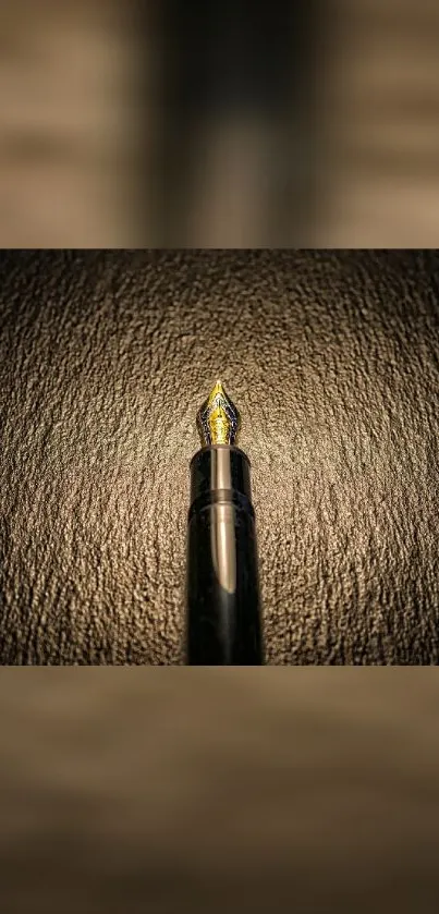 Elegant dark gold fountain pen on textured background.