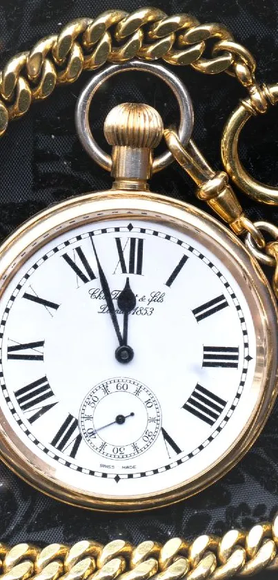 Elegant gold pocket watch on black textured background.