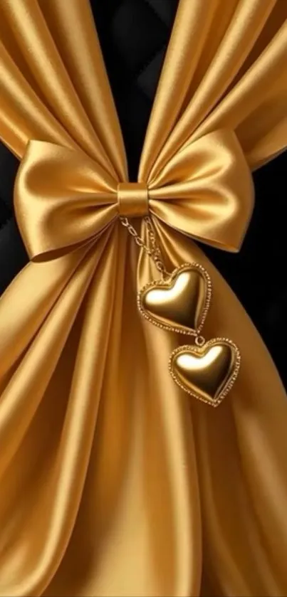 Gold satin ribbon with heart pendants against black background.