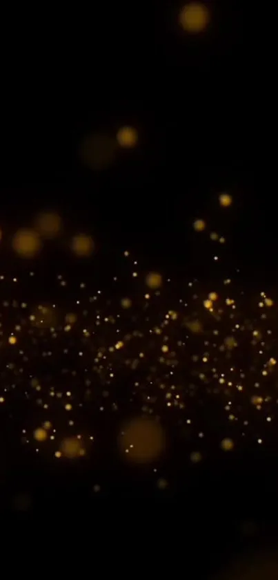 Gold sparkles on a black background, creating an elegant and luxurious wallpaper.