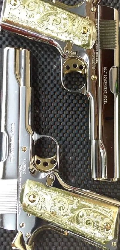 Two elegant golden handguns with engravings.