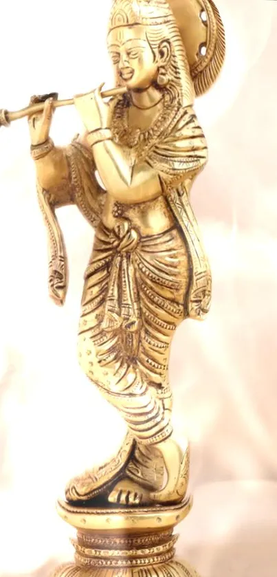 Golden Krishna statue wallpaper with artistic design.