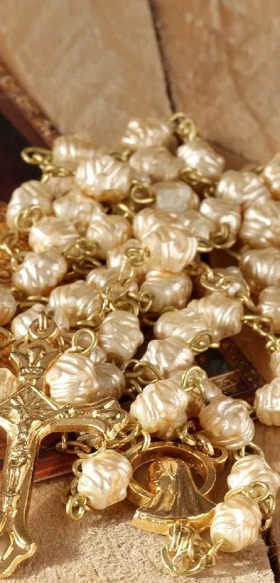 Rosary and religious icon on wood surface.