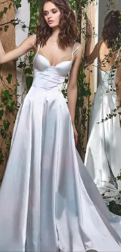 Woman in elegant white gown with mirror reflection.