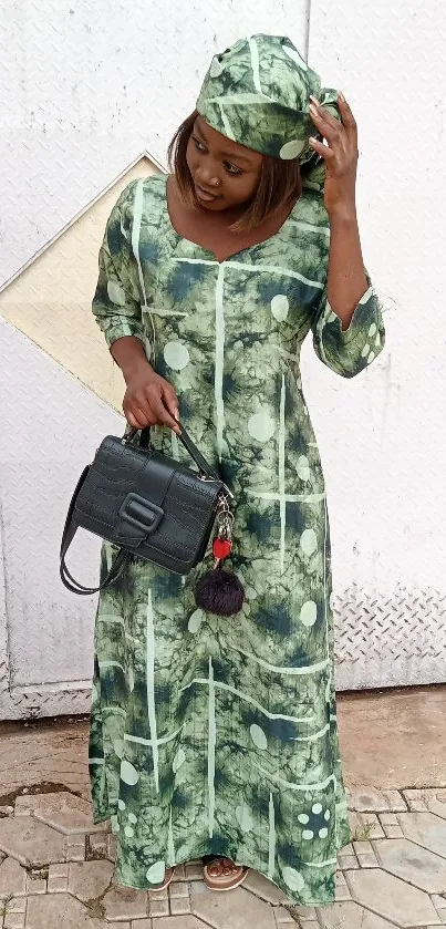 Woman in stylish green patterned traditional dress.