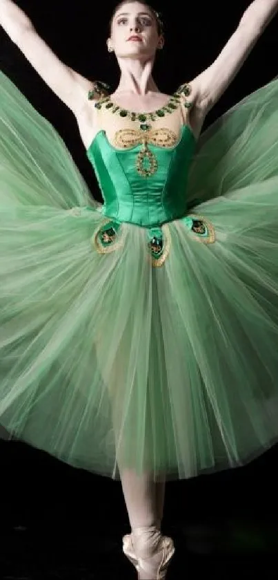 Ballet dancer in green tutu performing elegant pose against black background.