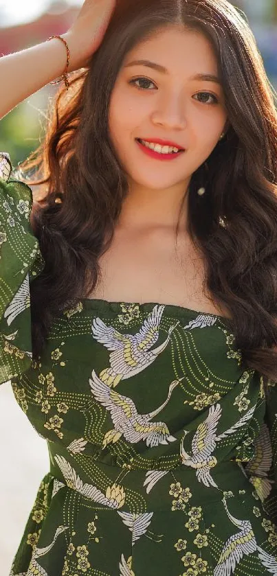 Woman in a green dress with bird pattern under the sun.