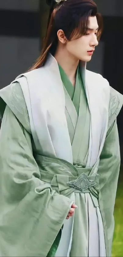 Serene figure in elegant green robe standing calmly.