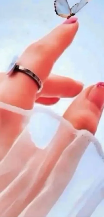 Elegant hand with butterfly on fingertip, set against light blue background.