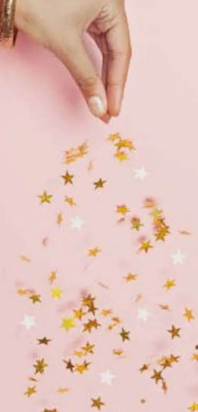 Hand with golden stars on pink background wallpaper.