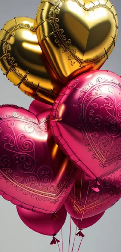 Gold and pink heart-shaped balloons against a soft gray background.