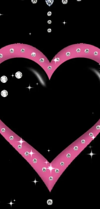 Pink heart with rhinestones on black background.