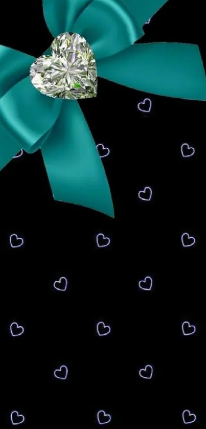 Teal bow with diamond heart on black background.