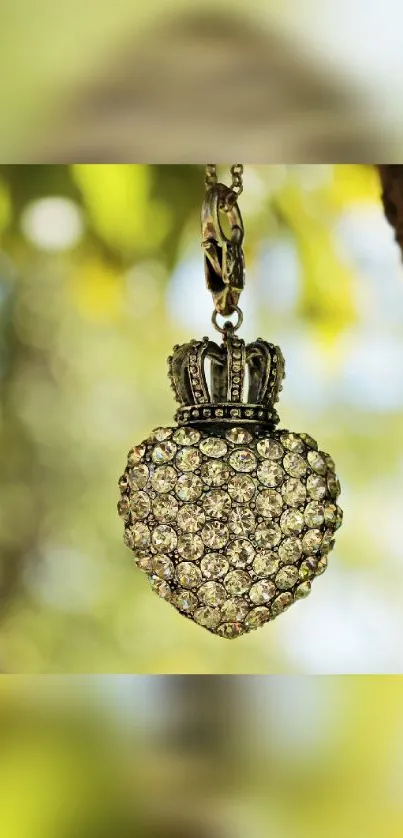 Heart-shaped jewel pendant hanging in nature background with green hues.