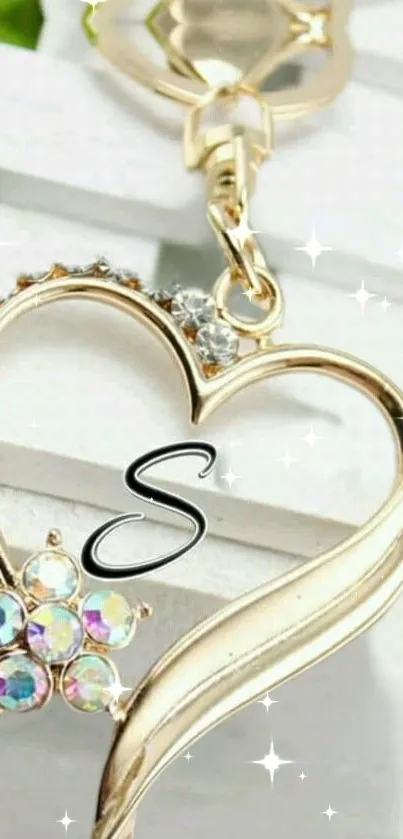 Elegant gold heart-shaped keychain with sparkling details on a white background.