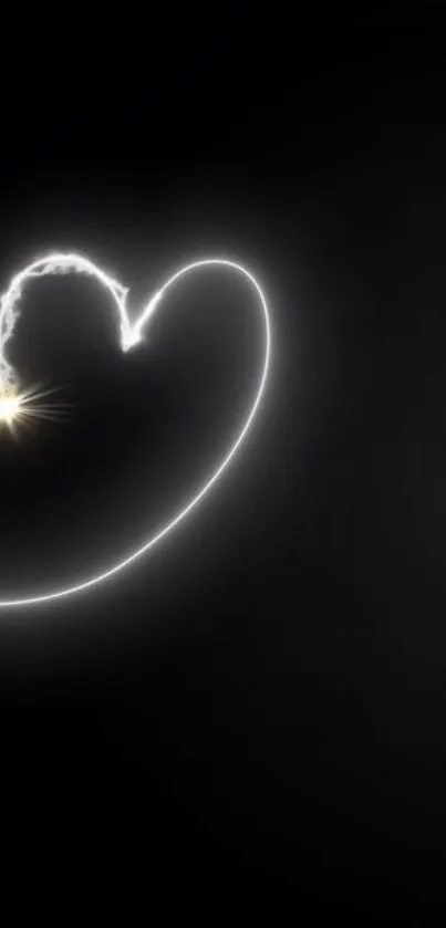 Heart-shaped light on black background wallpaper.