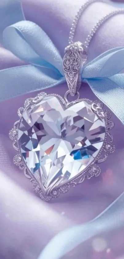 Heart-shaped crystal pendant on lavender fabric with a blue ribbon.