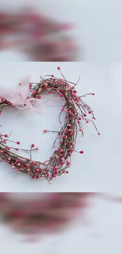 Heart-shaped wreath with pink berries on light gray background.