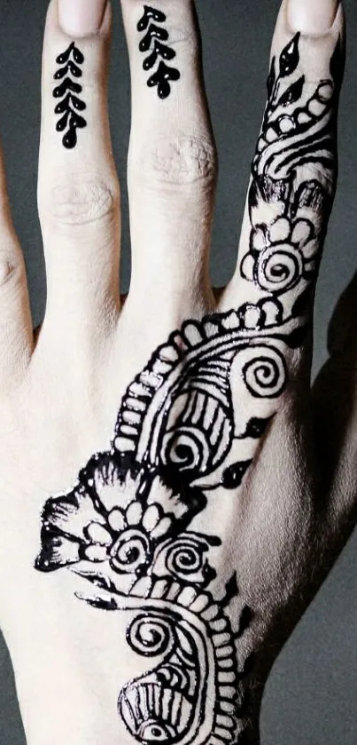 Hand with intricately designed henna art on a light beige background.