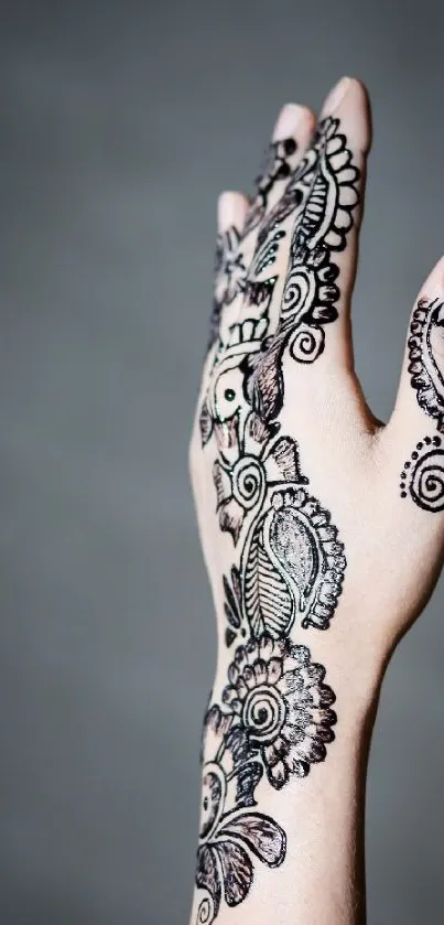 Intricate henna hand design on muted gray background wallpaper.