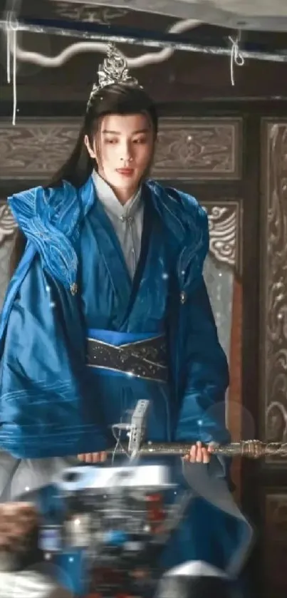 A serene figure in blue robes with an ornate backdrop.