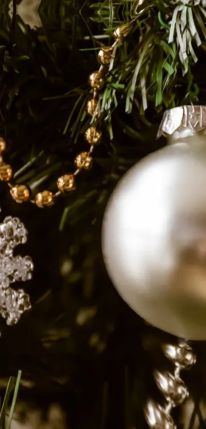 Elegant Christmas ornaments on a green tree branch.