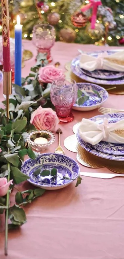 Elegant holiday table setting with blue china and pink accents.