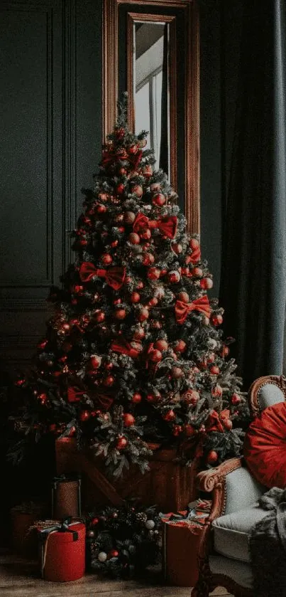 Elegant Christmas tree with red and gold decorations in a cozy living room setting.