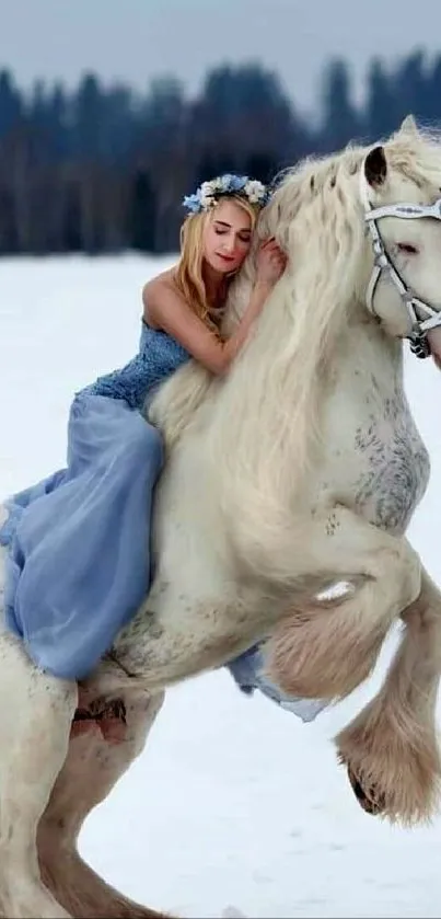 Woman in blue dress on white horse in winter landscape.